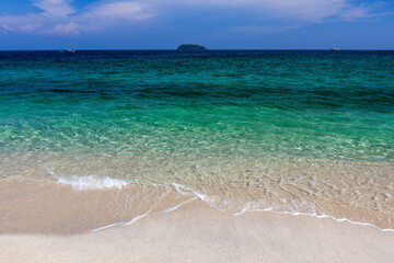 Crystal clear emerald colored sea meets pristine sandy beach. Koh Adang, Thailand. Beautiful see background.