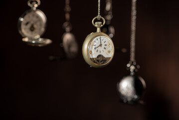 Pocket watch, beautiful and antique pocket watches hanging in front of an abstract background,...