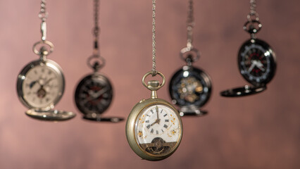 Pocket watch, beautiful and antique pocket watches hanging in front of an abstract background,...