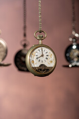 Pocket watch, beautiful and antique pocket watches hanging in front of an abstract background,...