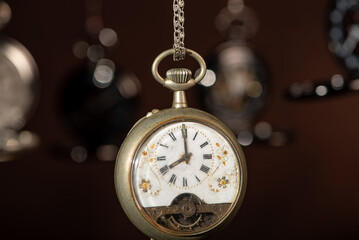 Pocket watch, beautiful and antique pocket watches hanging in front of an abstract background,...