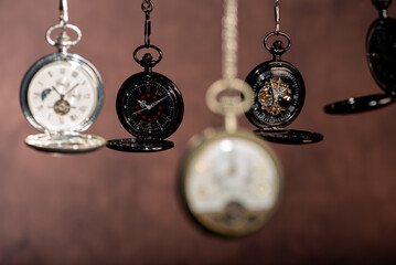 Pocket watch, beautiful and antique pocket watches hanging in front of an abstract background,...
