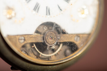 Pocket watch, beautiful and antique pocket watches hanging in front of an abstract background, selective focus.