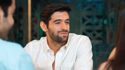 Fototapeta premium Portrait closeup smiling man having dinner of grill beef with friend group and couple in special meal at luxurious restaurant. Having a good time meeting festive day at lifestyle nightclub. Vinosity.