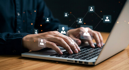 Person using laptop with network of people icons overlayed on the screen and dark background light sparks