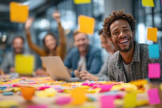 Group of professionals collaborate on project with sticky notes at long table in bright room, two people take a selfie - Powered by Adobe