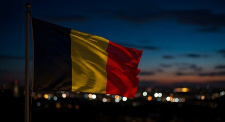 The Belgian flag proudly waving at dusk against a captivating bokeh city lights backdrop. Evokes national pride and a sense of evening tranquility.