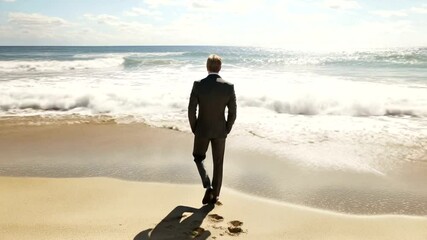 Businessman standing on beach, looking out at ocean waves - Powered by Adobe