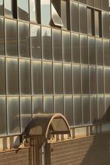 A large building designed with numerous windows that allow natural light in, complemented by a...