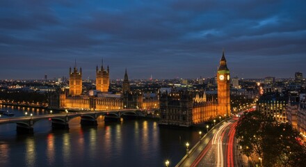 Obraz premium Night view of the Houses of Parliament and Big Ben in London, England, with a river and city lights.