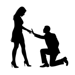 Man proposes to woman, kneeling reaching for her hand