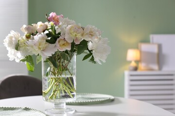 Beautiful table setting with vase of flowers in dining room, space for text