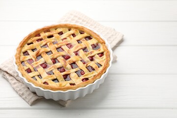Tasty cherry pie on white wooden table, space for text