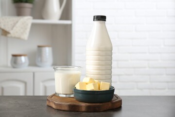 Different dairy products on gray textured table in kitchen