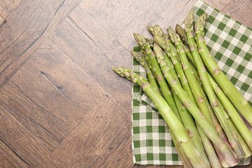 Fresh raw asparagus on wooden table, top view. Space for text