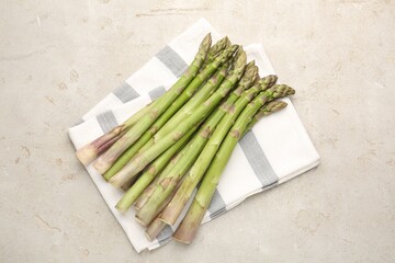 Fresh raw asparagus on light grey table, top view