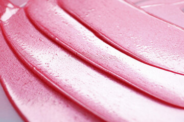 Texture of pink lip gloss as background, closeup
