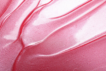 Texture of pink lip gloss as background, above view