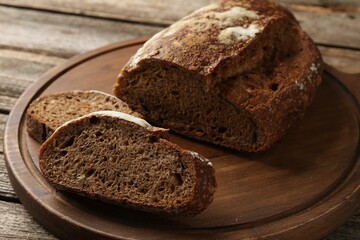Pieces of fresh rye bread on wooden table, closeup