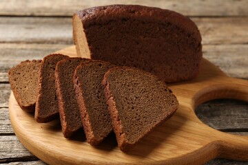 Pieces of fresh rye bread on wooden table, closeup