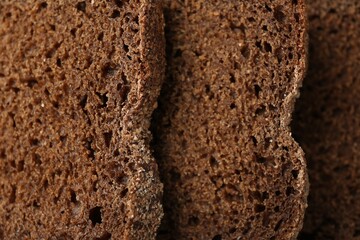 Pieces of fresh rye bread as background, closeup