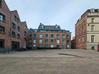 quiet courtyard surrounded by historic red brick in Lille, France