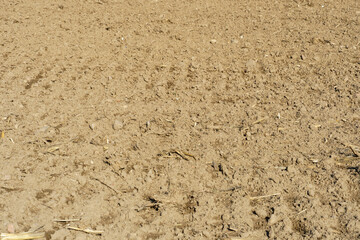 Rows of soil before planting. Drawing of furrows on a plowed field prepared for spring sowing of agricultural crops. View of the land prepared for planting and growing crops.