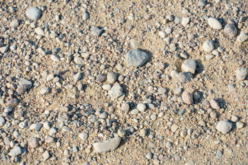Background of small stones on the road. Pebbles on the beach.
