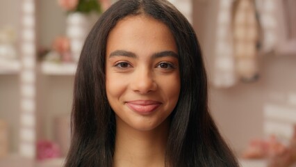 Portrait beautiful ethnic Latina Hispanic woman teenager serious emotion girl close up face makeup...