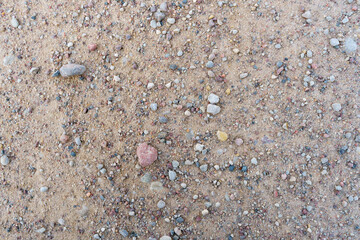 Background of small stones on the road. Pebbles on the beach.