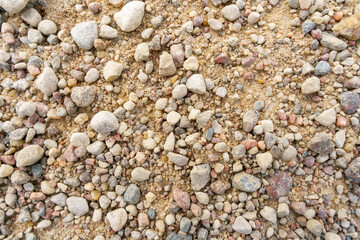 Background of small stones on the road. Pebbles on the beach.