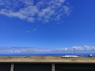 A clear blue sky with a few clouds