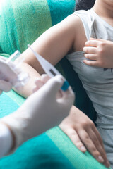 Vertical shot of healthcare professional measuring an individual's temperature using a digital thermometer, emphasizing health, diagnosis, and patient care, focus on background.
