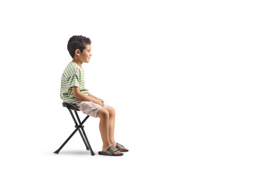Fototapeta premium Boy sitting on a portable chair