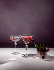 Elegant cherry cocktails garnished with fresh cherries on a table