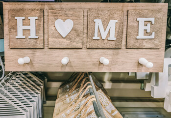 A wooden sign with the word home written on it