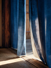 Tranquil scene with blue curtains softly filtering sunlight in a serene, zen-like room interior space showcasing texture