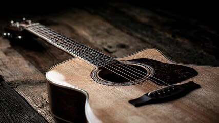 Artistic arrangement of an acoustic guitar on a natural wood backdrop highlighting the craftsmanship with focus on the body curves and string tension ideal for promoting musical artistry.