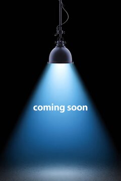 Spotlight shining on dark background with coming soon text.