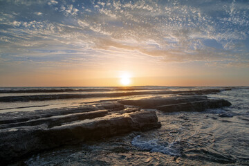 A perfect sunset illuminates the horizon and sky. Beautiful summer sea landscape. Ocean shore....