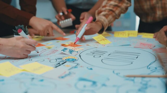 A dynamic scene of diverse people collaborating in a workshop, surrounded by colorful sticky notes and vibrant drawings, fostering creativity and teamwork in an inviting office space. SACTR