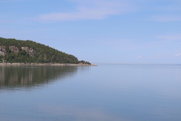 A bay in Charlevoix country in Quebec. Vast horizon St-Laurent river in Charlevoix. Blue and peaceful landscape. Panorama of a summer landscape.