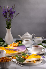 Delicious lavender and yellow raspberry cheesecake with tea set