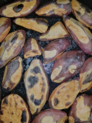 These sweet potatoes, perfectly roasted in the oven with a hint of salt and a light drizzle of oil, showcase a beautifully caramelized exterior and a delightfully crunchy texture.