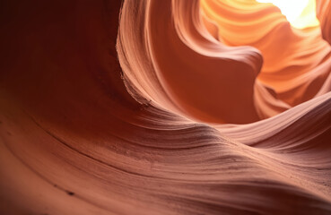 Stunning red rock canyon formation in Arizona Navajo country. Magnificent landscape with winding red rock cliffs. Curved shape, light red tones, deep red hue. Low angle shot, sandy rocky foreground.