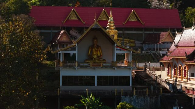 Golden buddha statue sitting in meditation pose at wat pong yaeng nok buddhist temple, a beautiful temple in thailand