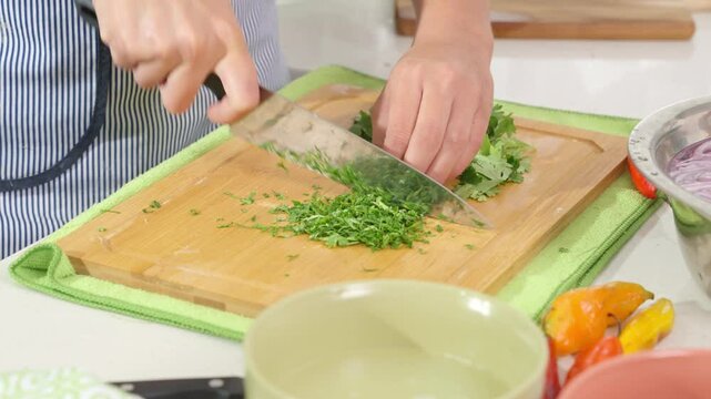 Chef cutting cilantro for peruvian ceviche preparation