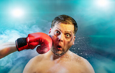 Shocked man getting punched by red boxing glove getting hit in face  with dramatic impact