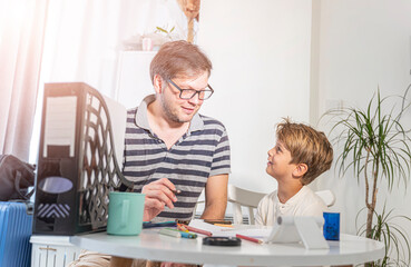 Father and son are doing their homework for school
