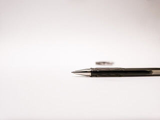 Minimalistic black gel pen on a white background